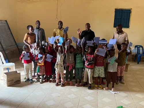 Children and adults presenting learning materials in a classroom