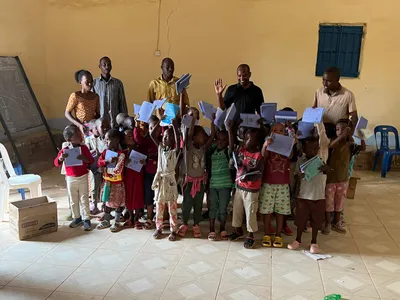 Children and adults presenting learning materials in a classroom
