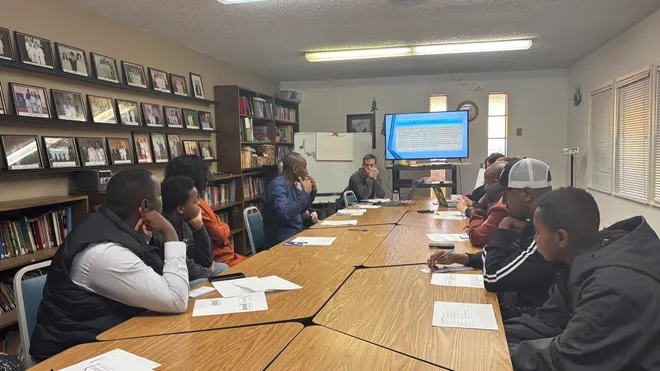 Adults listening during a presentation around a meeting table